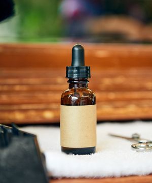 Beard oil and tools laid out on the counter