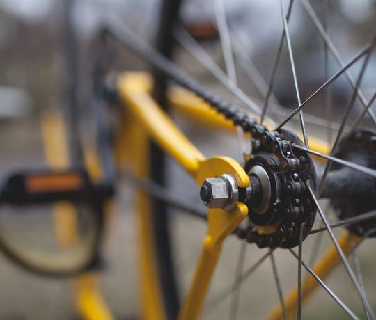The hub and spokes of a wheel on the stand