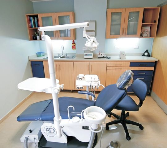 A treatment room, chair and light