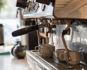 The espresso machine and warmed cups